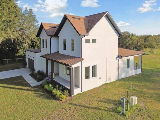 view of property exterior featuring a lawn, a porch, and a garage