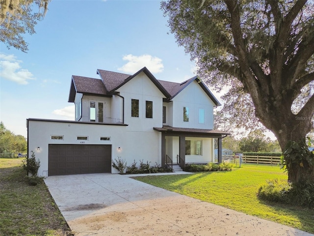 view of front of property with a garage and a front yard