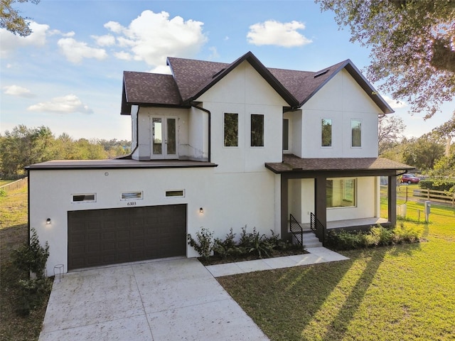 view of front of house with a front lawn and a garage