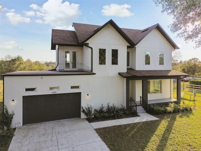 view of front of property with a porch, french doors, a garage, and a front lawn