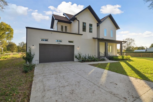 view of front of house featuring a porch, a garage, and a front yard