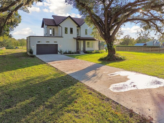 view of front of home featuring a garage and a front lawn