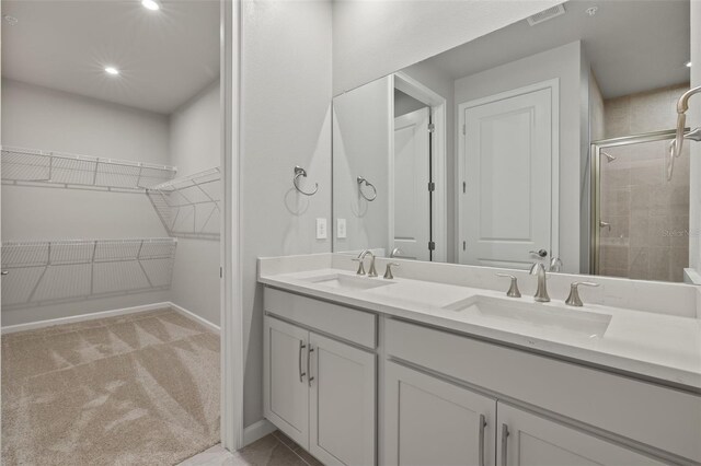 bathroom with vanity and a shower with shower door