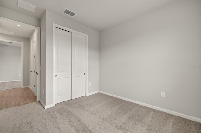 unfurnished bedroom featuring carpet floors and a closet