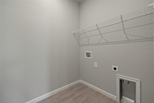 laundry room featuring hookup for a washing machine, light hardwood / wood-style floors, and hookup for an electric dryer