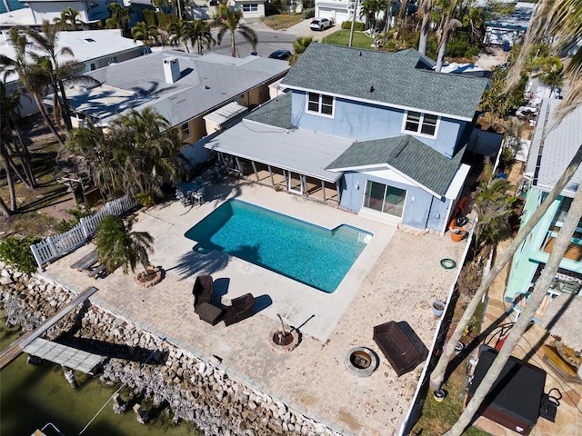 view of pool featuring a patio and an outdoor living space with a fire pit