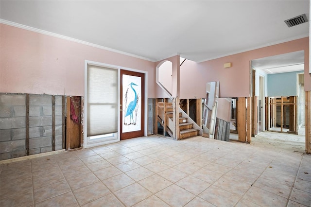 foyer entrance featuring crown molding