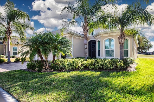 mediterranean / spanish-style house featuring a front lawn