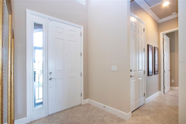 tiled entrance foyer featuring plenty of natural light and ornamental molding