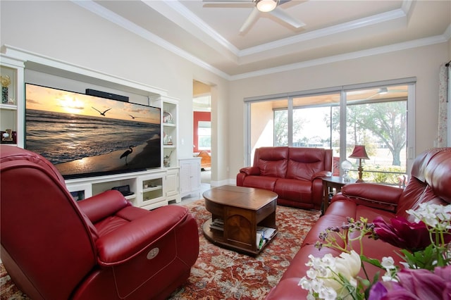 living room featuring ceiling fan, crown molding, and a tray ceiling