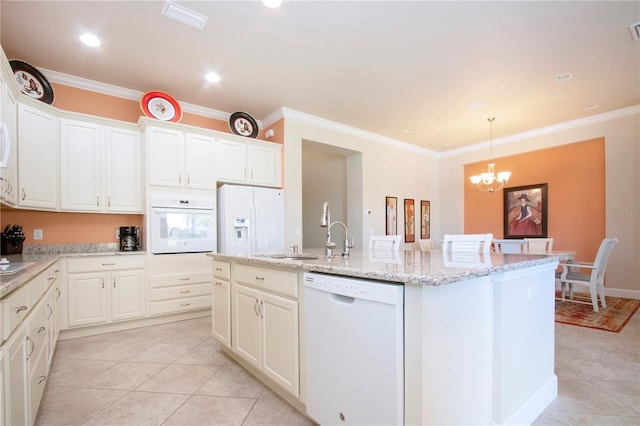 kitchen featuring white appliances, a kitchen island with sink, crown molding, decorative light fixtures, and a chandelier