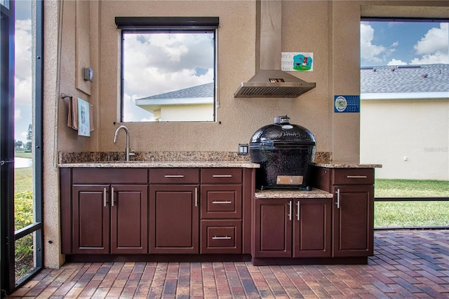 kitchen with sink, plenty of natural light, and ventilation hood