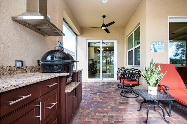 view of patio with ceiling fan and area for grilling