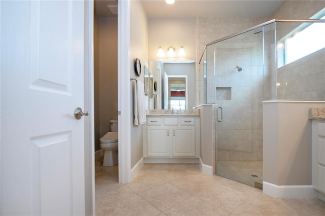 bathroom with tile patterned floors, vanity, an enclosed shower, and toilet