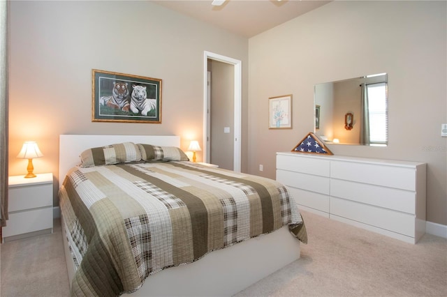 bedroom with ceiling fan and light carpet