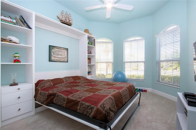 carpeted bedroom with multiple windows and ceiling fan