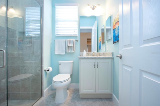 bathroom featuring tile patterned flooring, vanity, toilet, and a shower with door