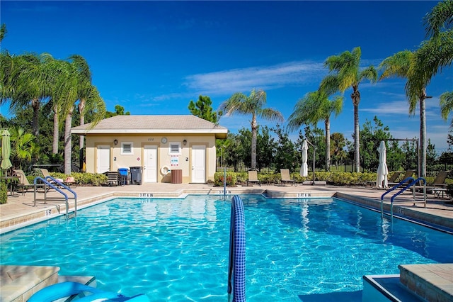 view of pool featuring a patio and an outdoor structure