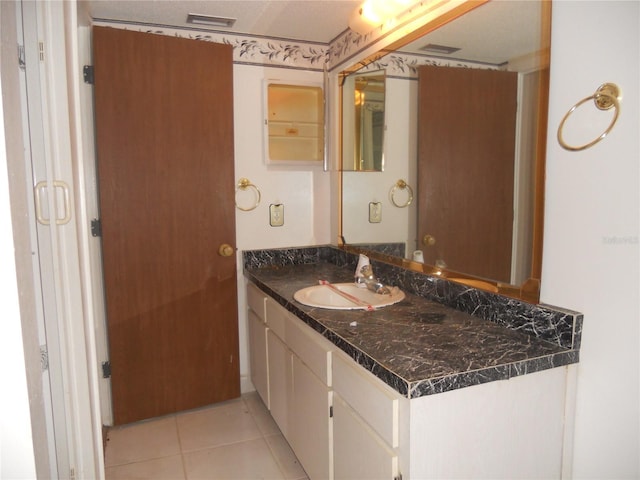 bathroom featuring tile patterned flooring and vanity