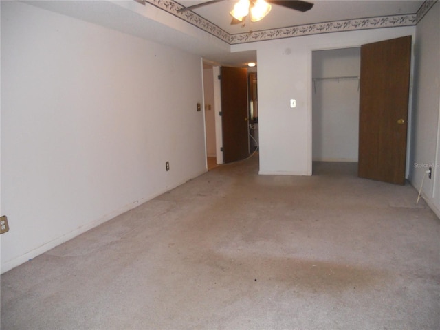 unfurnished bedroom with ceiling fan, a closet, and light carpet