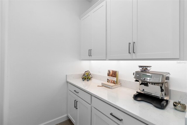 bar featuring white cabinets