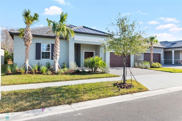 view of front facade featuring a front yard and a garage