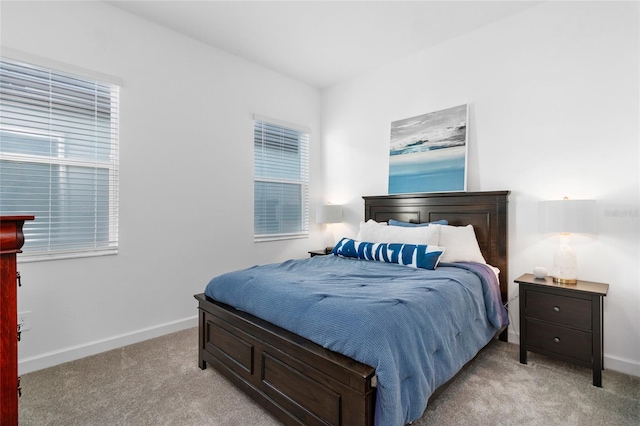 bedroom featuring light carpet