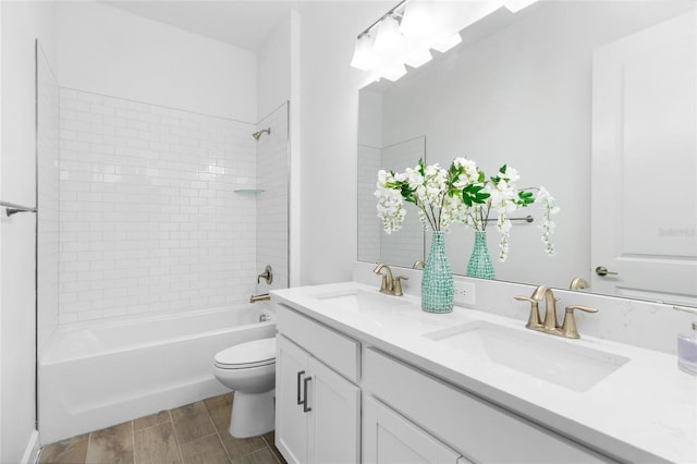 full bathroom featuring vanity, toilet, and tiled shower / bath