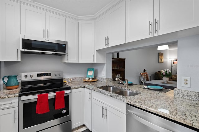 kitchen featuring stainless steel appliances, white cabinetry, and sink