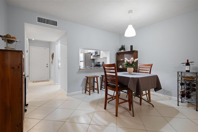 dining area with light tile patterned flooring