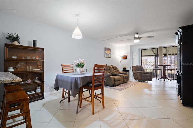 dining room with ceiling fan and light tile patterned flooring