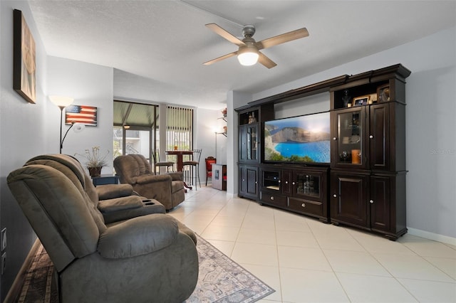 living room with light tile patterned floors, a textured ceiling, and ceiling fan