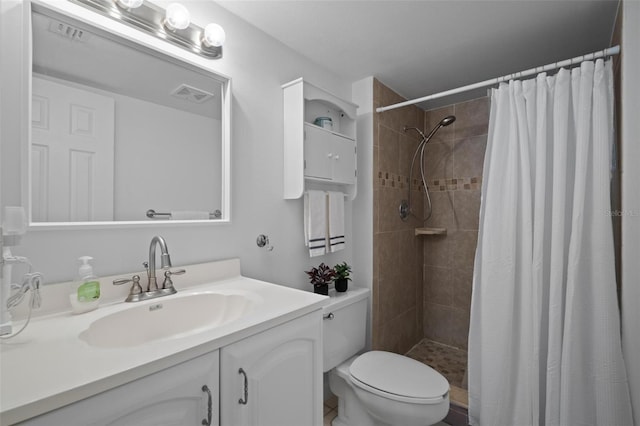 bathroom featuring vanity, curtained shower, and toilet