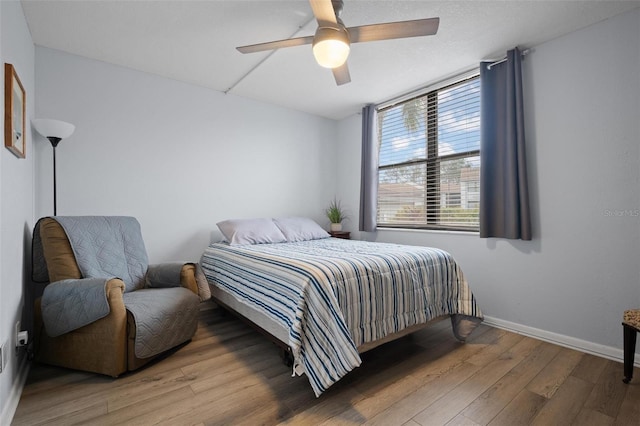 bedroom with ceiling fan and hardwood / wood-style flooring