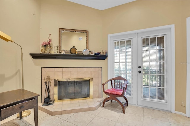 sitting room with light tile patterned floors and a tiled fireplace