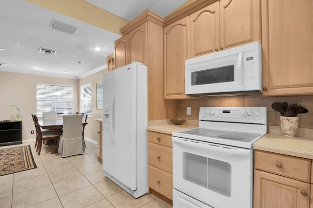 kitchen with light brown cabinets, white appliances, crown molding, and light tile patterned floors