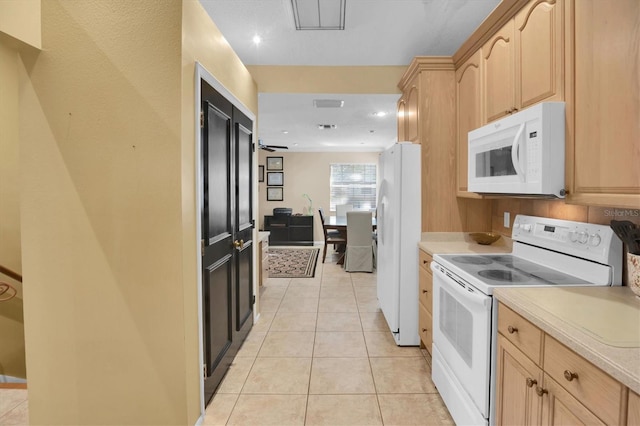 kitchen featuring light brown cabinetry, white appliances, ceiling fan, and light tile patterned flooring