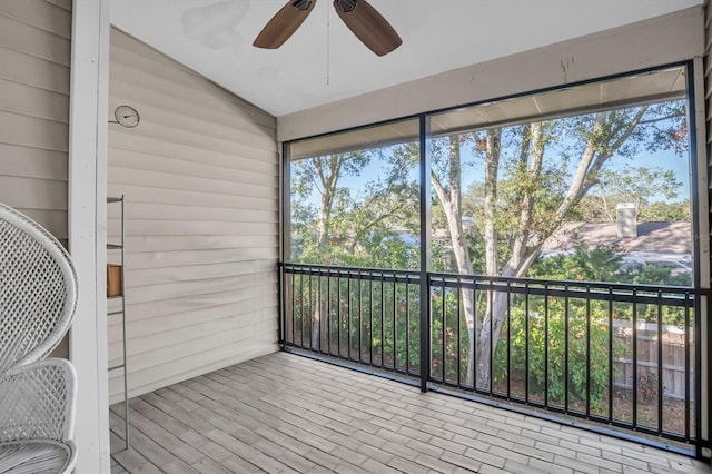 unfurnished sunroom with ceiling fan and lofted ceiling