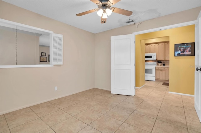 tiled spare room featuring ceiling fan and a textured ceiling