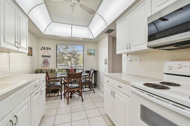 kitchen with light tile patterned floors, white cabinetry, white range with electric cooktop, and ceiling fan