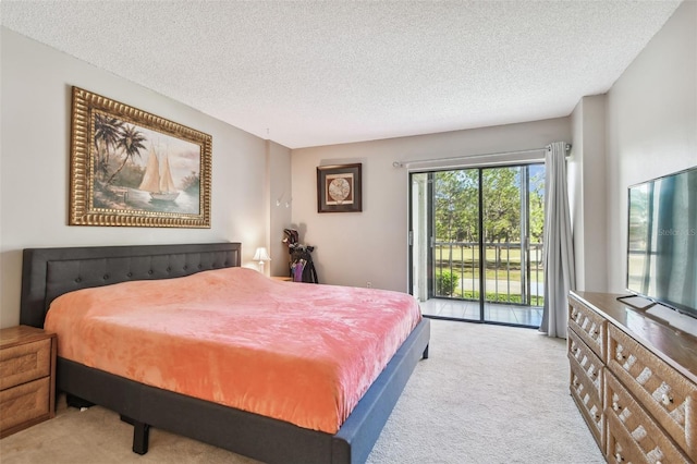 carpeted bedroom with access to outside and a textured ceiling