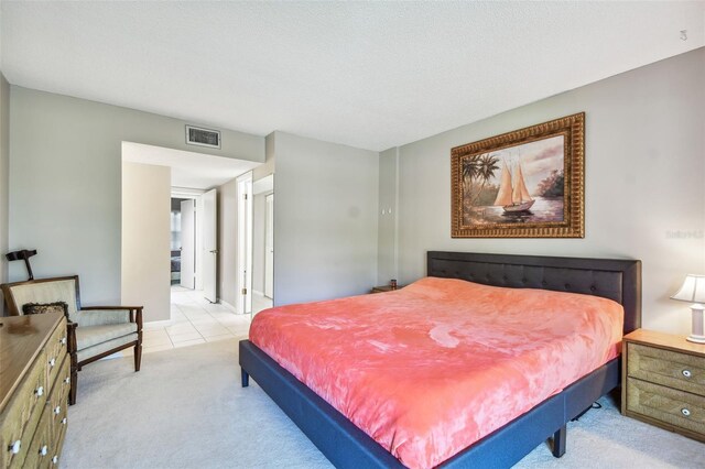 carpeted bedroom with a textured ceiling