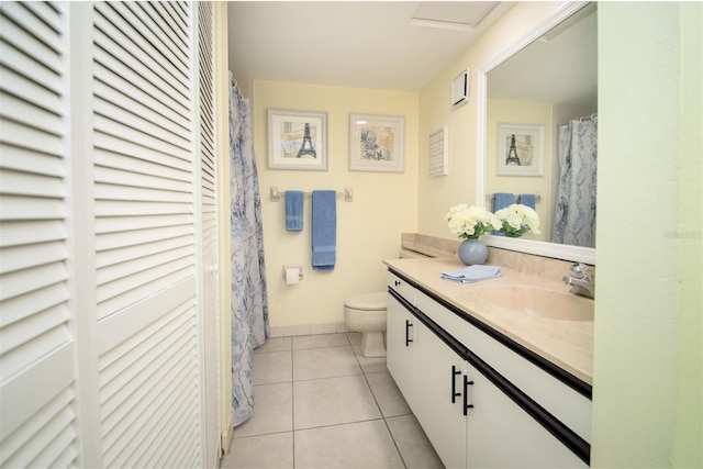 bathroom with tile patterned flooring, vanity, and toilet