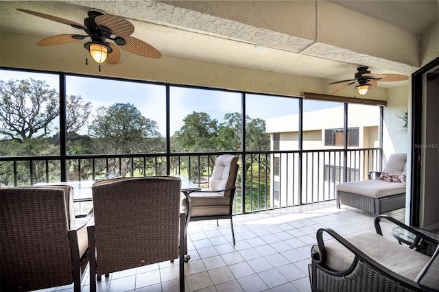 sunroom / solarium featuring ceiling fan