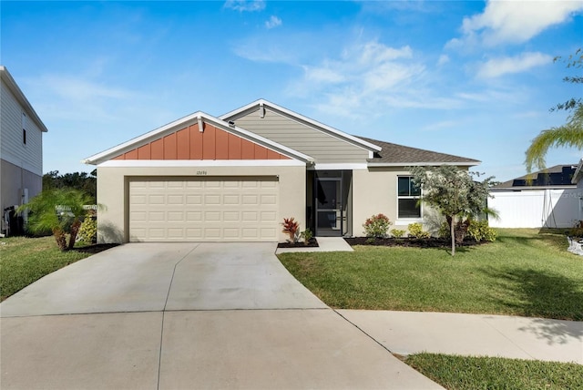 view of front of house with a front yard and a garage