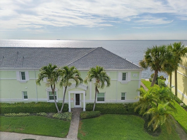 view of front facade with a water view and a front yard