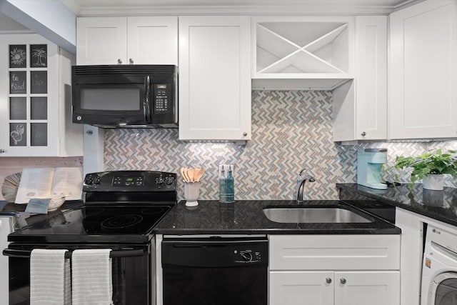 kitchen with sink, white cabinets, black appliances, and washer / dryer