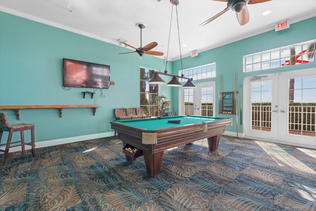 rec room with french doors, dark carpet, ornamental molding, and a healthy amount of sunlight