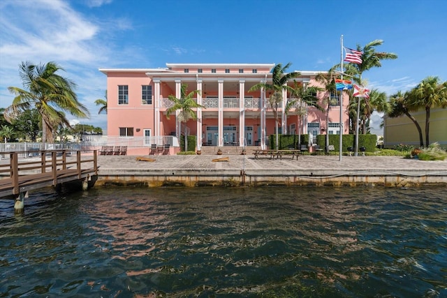 rear view of house with a water view and a balcony