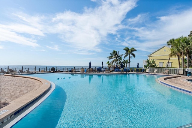 view of swimming pool featuring a water view